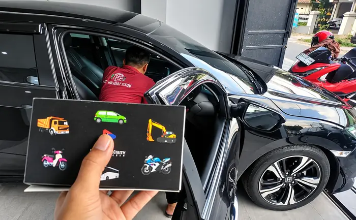 Teknisi memasang GPS tracker KIDO Connect pada mobil